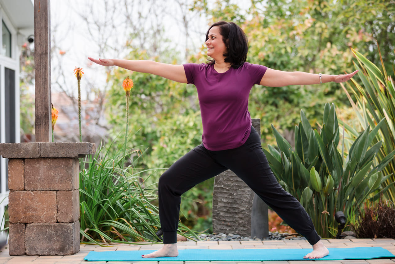 Dr. Malathi Acharya practicing yoga, reflecting the mind-body approach of Ayurvedic medicine